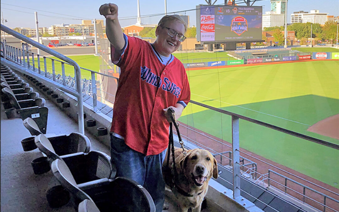 Andrew Crane and his guide dog Vaughn at Wichita’s Riverfront Stadium